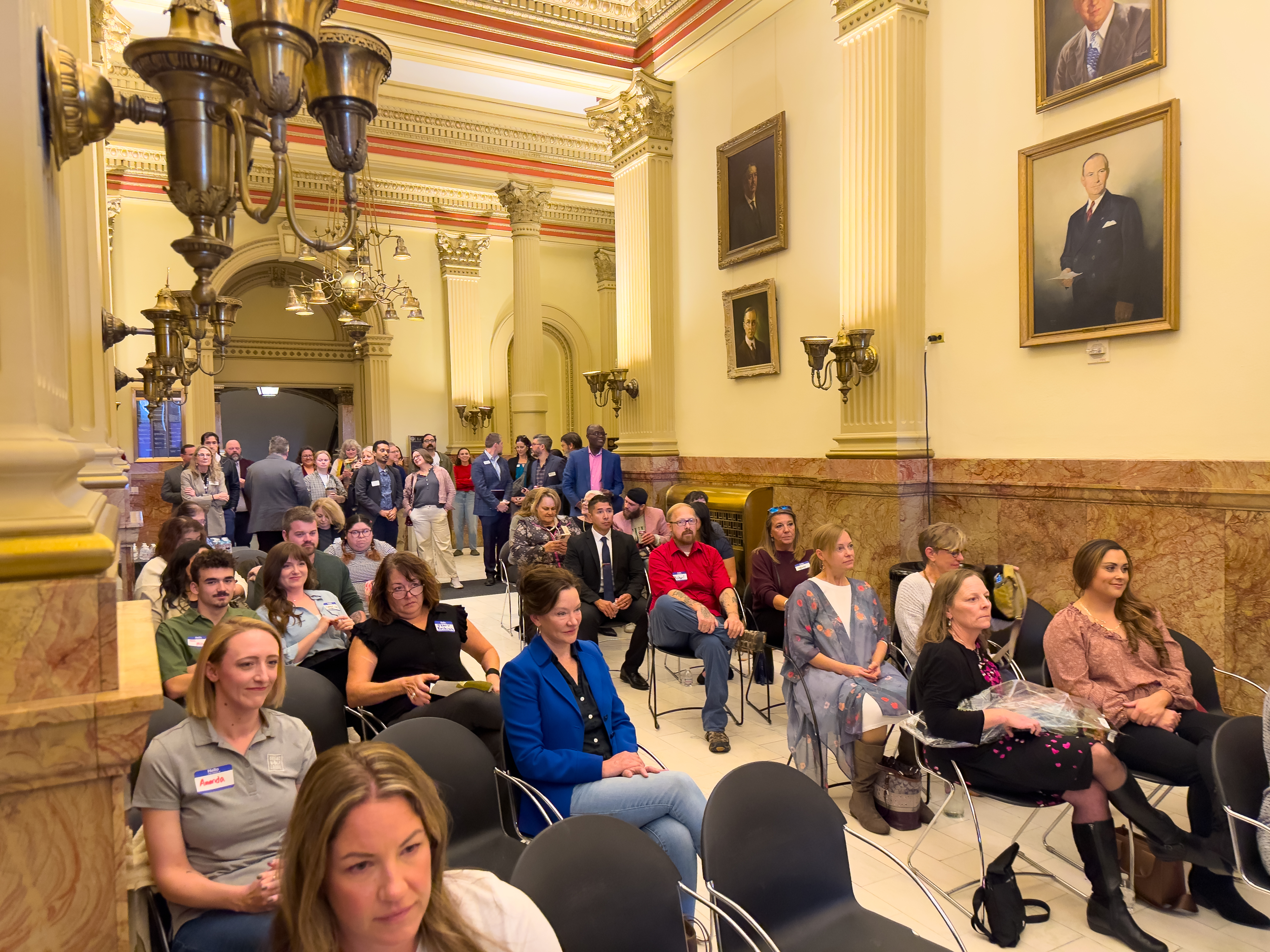 A large crowd fills the hallway of the East Foyer at the Capitol building for the 2025 NDEAM Celebration.