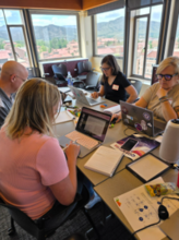 A group of people working around a conference table